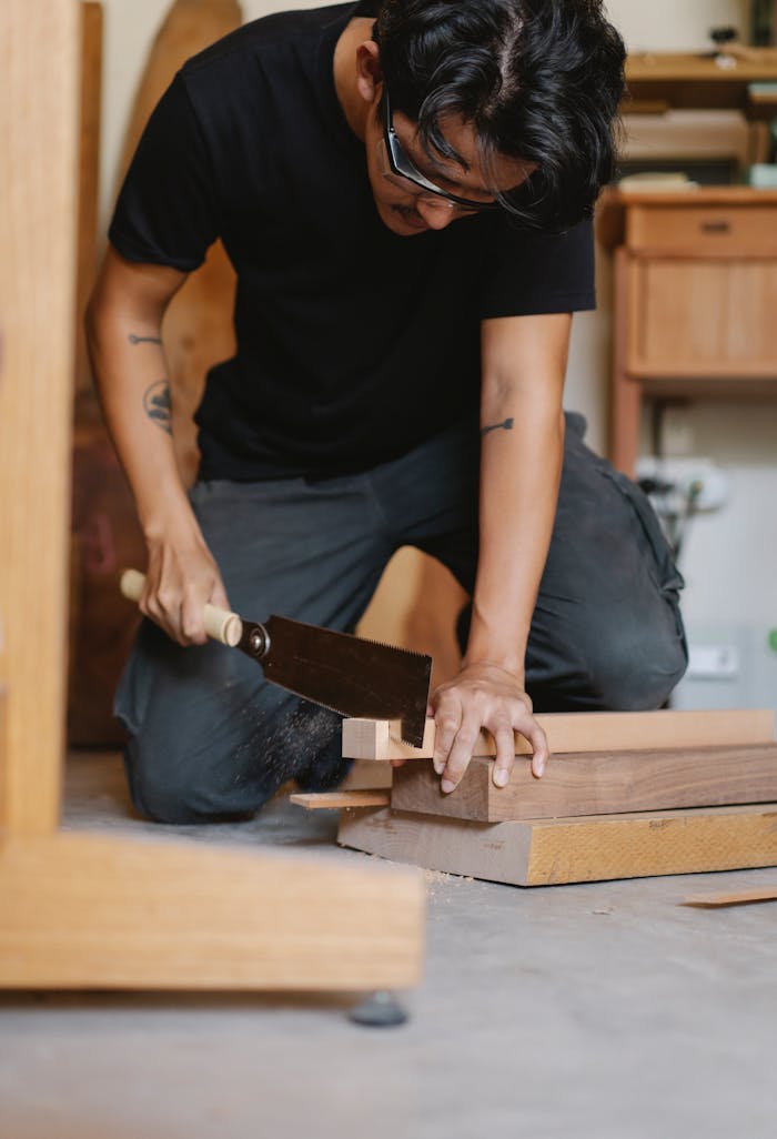 A skilled craftsman concentrating on precise woodworking in a studio setting.
